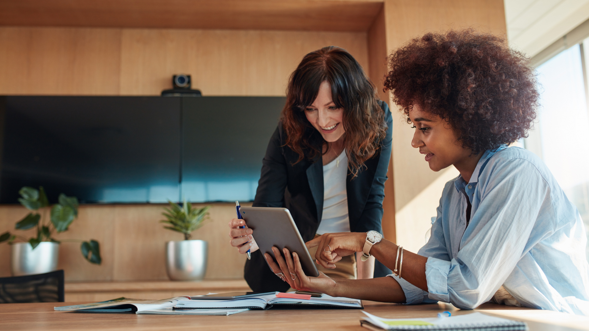 Consultants reviewing digital plans on a tablet—representing business change, digital readiness, and collaborative transformation in the public sector